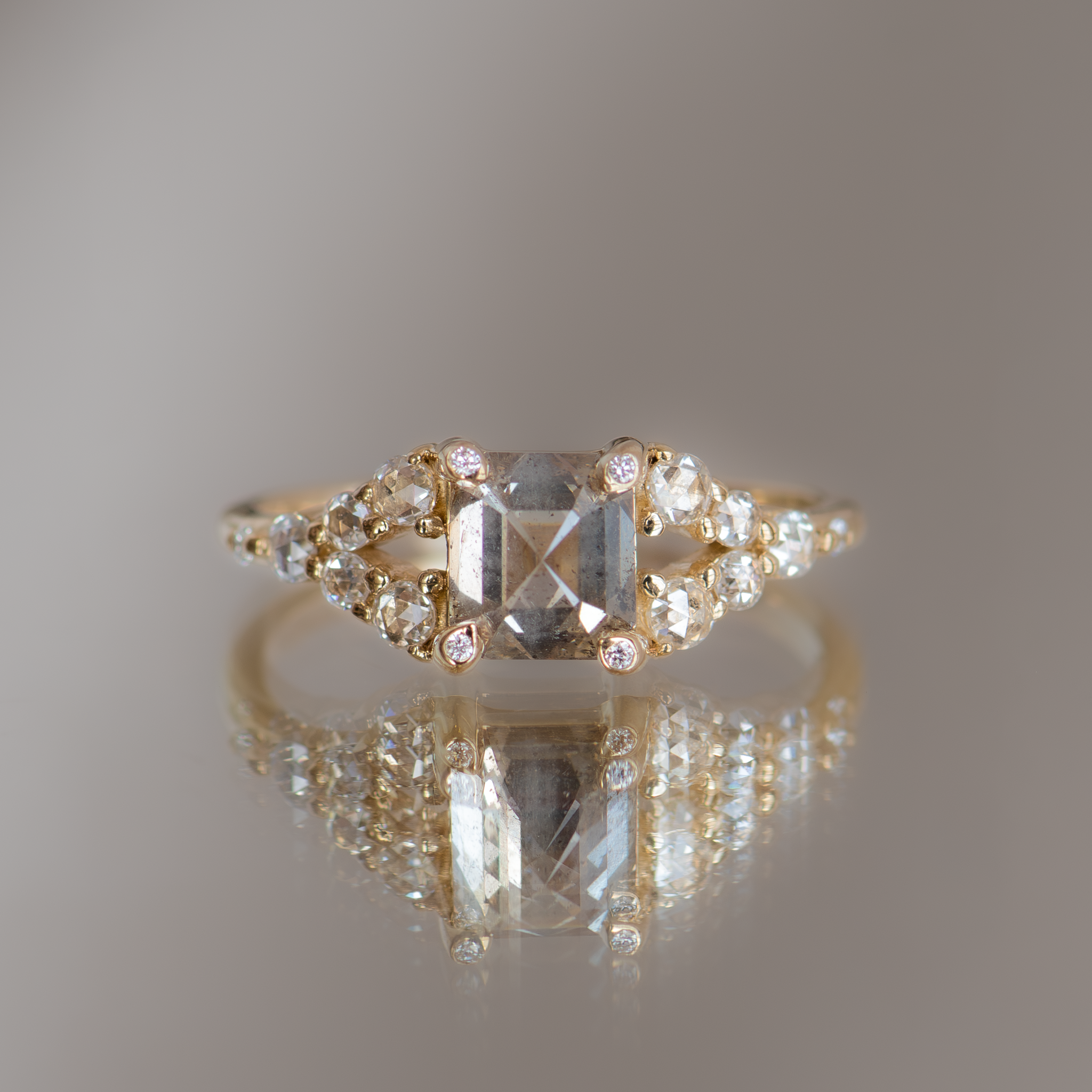Emerald cut salt and pepper diamond ring.