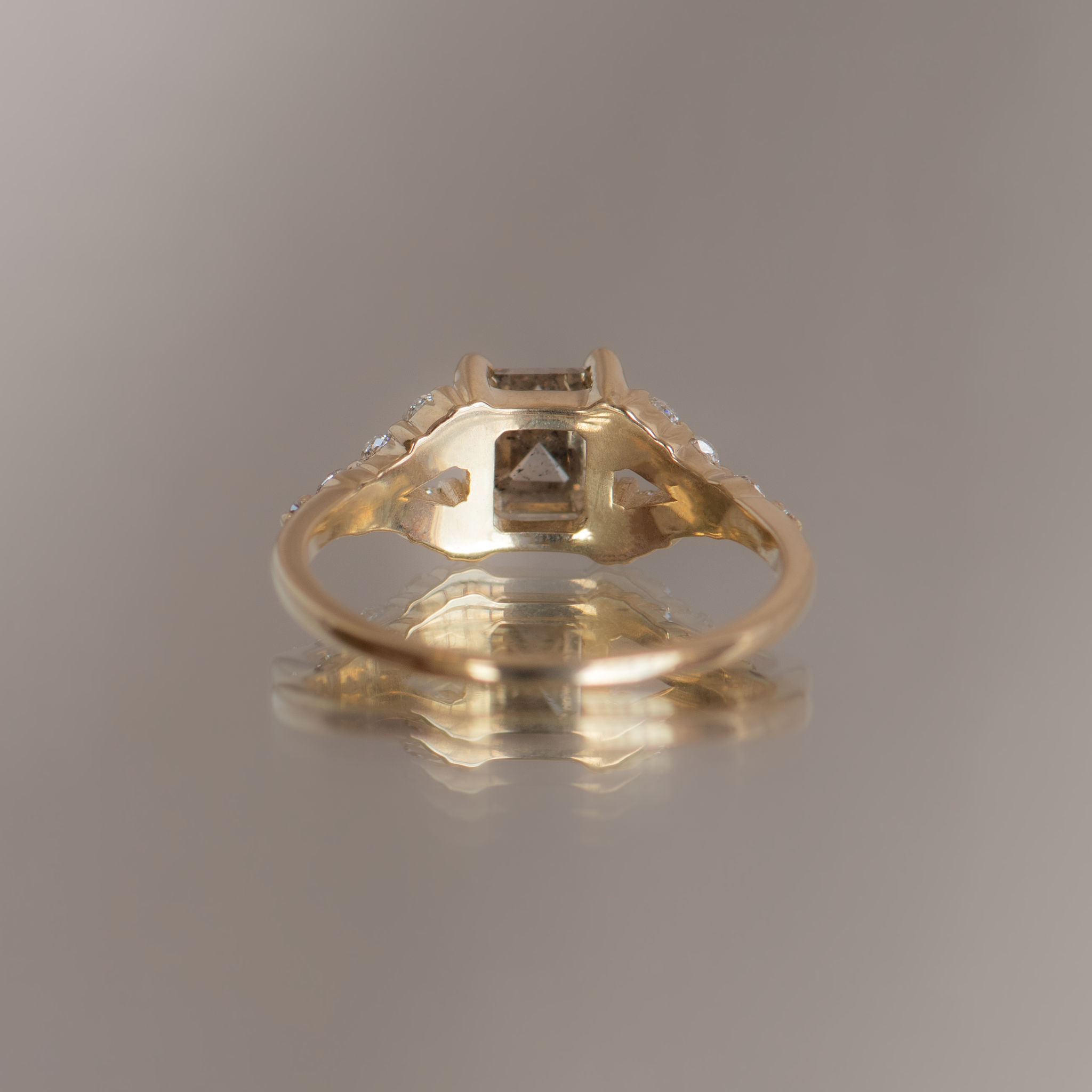 Emerald cut salt and pepper diamond engagement ring with split band, made with rose cut diamonds in 14k yellow gold.