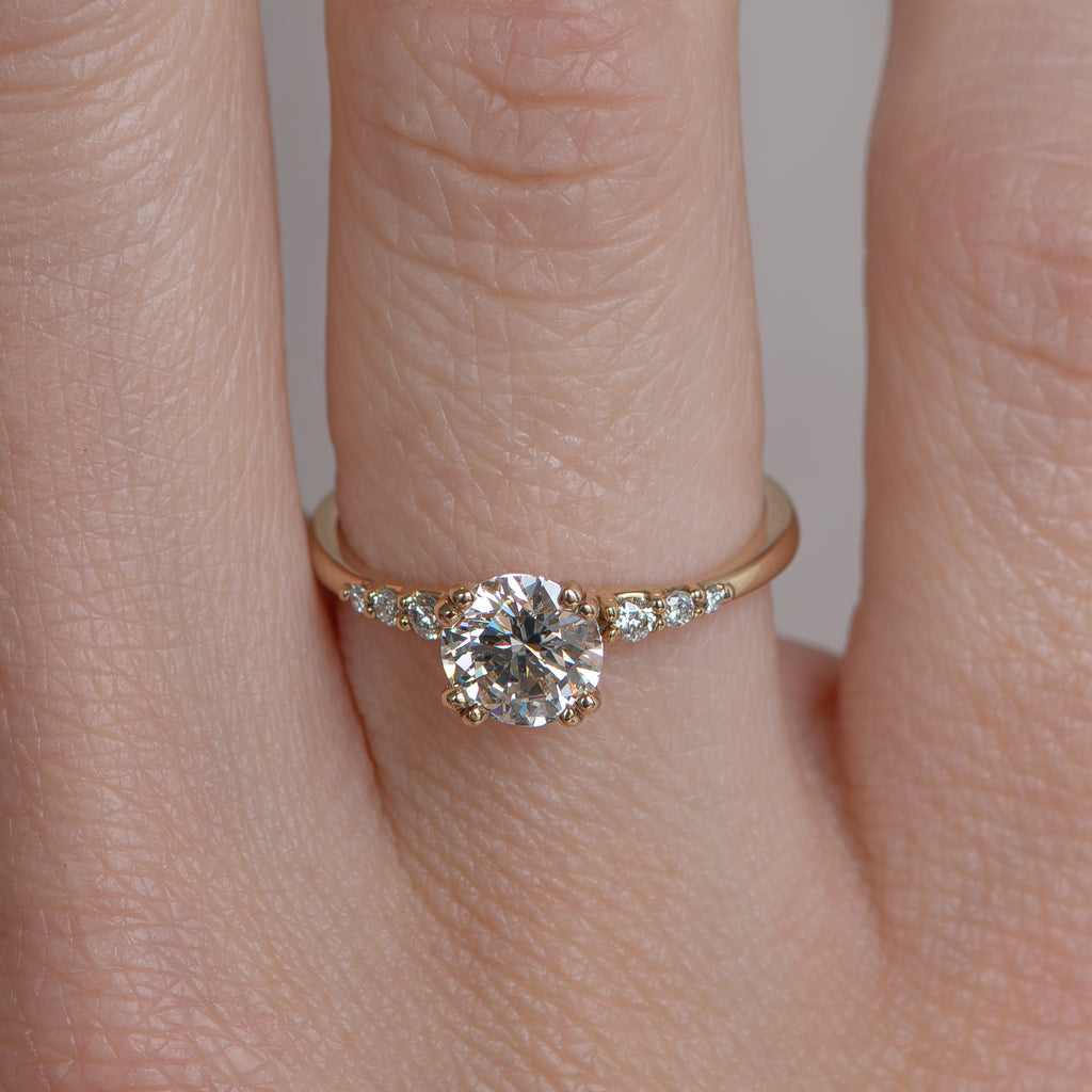 Delicate solitaire diamond engagement ring, set with four double prongs, made in 14k or 18k yellow gold