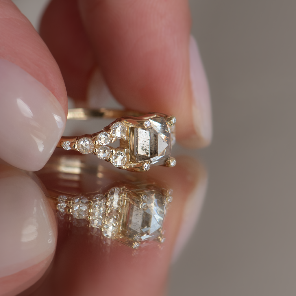  Emerald cut salt and pepper diamond engagement ring with split band, made with rose cut diamonds in 14k yellow gold.