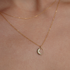 Gold crescent charm